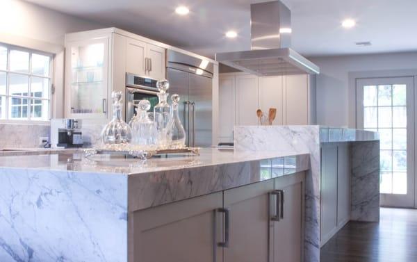 Waterfall edge Carrara Marble Countertops fabricated and installed by Summit Stoneworks.