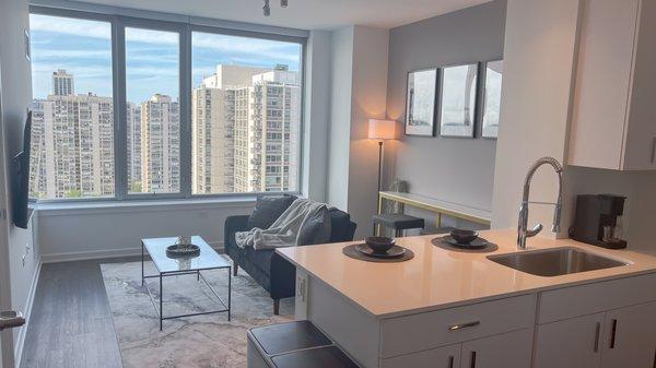 Living area and kitchen of one of our furnished apartments