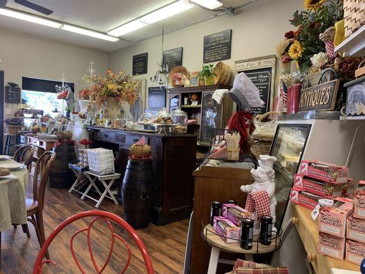 French shop ambience with gourmet gifts, a couple of little tables for lunch and charming flowers. Aroma of fresh baked artisan breads.