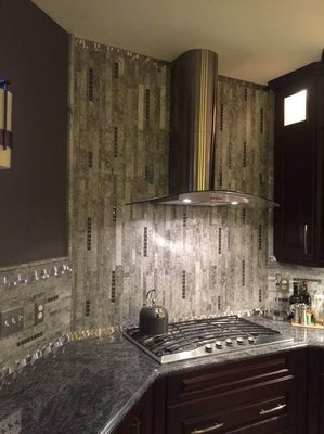 Siberian limestone, metal, and glass mosaic backsplash