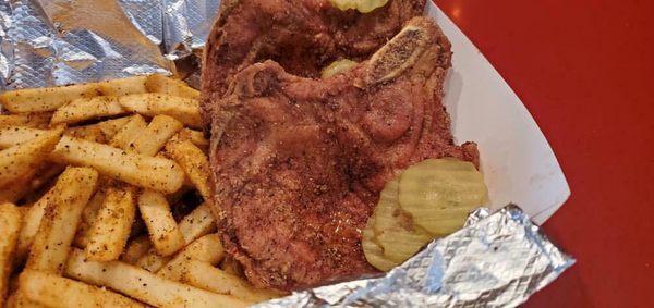 Fried pork chop plate with Cajun fries.