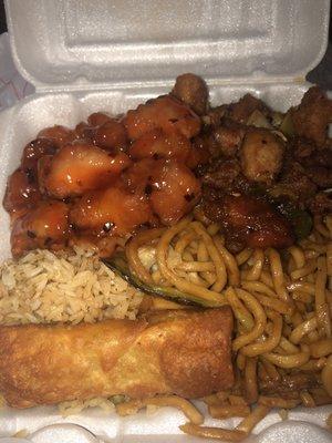 Clockwise from the top: Kung Pao Chicken, noodles, rice, egg roll, general tso