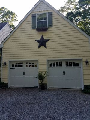 Above & Beyond Garage Doors installed another Carriage House Style Doors giving this home in Mount Sinai an elegant and Distinctive Look.