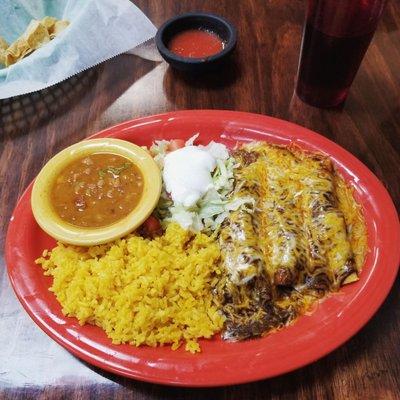 Enchiladas con mole sauce plate.