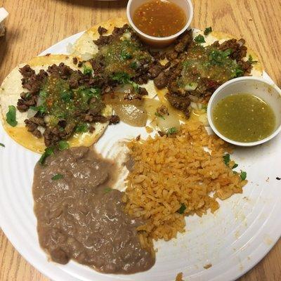 Street taco Al Pastor (marinated pork or carne asada.I got two of each and an order of beans and rice.