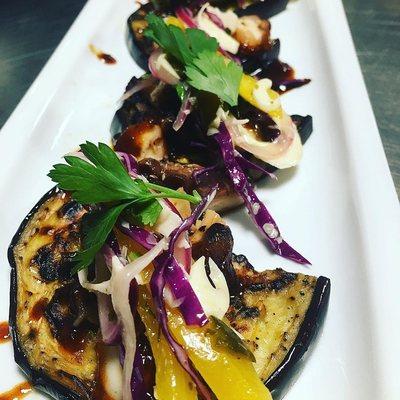 Wood fire grilled octopus with anchovies chili glaze and hearts of palm on charred eggplant.