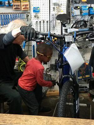 Technicians aren't born, they are made, here is my favorite one "in the making".  lol he spins the pedals while i lube them. He's learning.