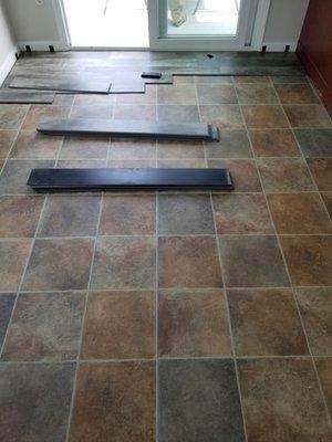 Luxury vinyl flooring covering old outdated tile floor