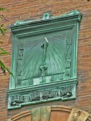 Bronze vertical sundial (3'x4') on south face of tower approx 30' above street level.