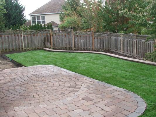 Part way finished yard with lawn, pavers, and retaining wall. Can you see this being your yard?