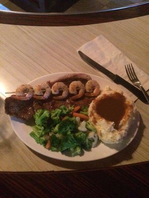 steak and shrimp with homemade potatoes and gravy !  can't forget your sides!