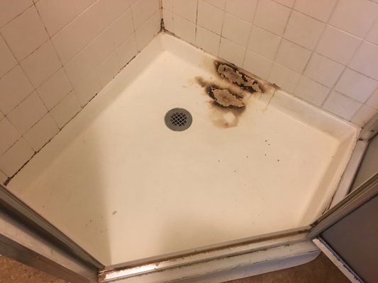 Burnt shower pan before