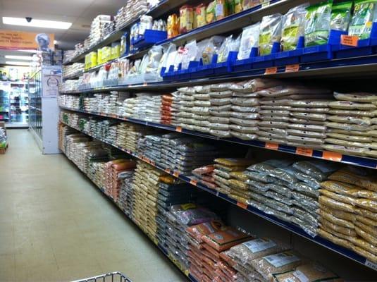 Wall of mostly dried staples: beans, grains, flours.