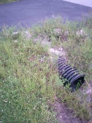 A fine example of a cheap plastic culvert they installed with the visible crack along the width of the driveway enterance