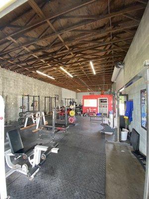 Entrance and front area with squat and bench racks.