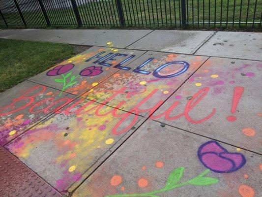 On the sidewalk in front of museum