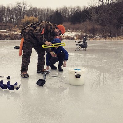 Teaching an aspiring young fishing guide to set a tip up.