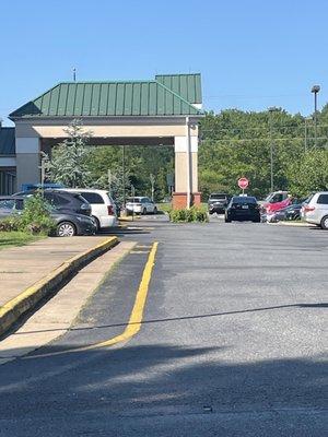 Employee parked illegally in the street in front of hotel preventing clients from traversing through the parking lot.