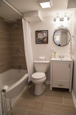 Basement bathrooms don't have to feel dark...choose light colors and tiles!