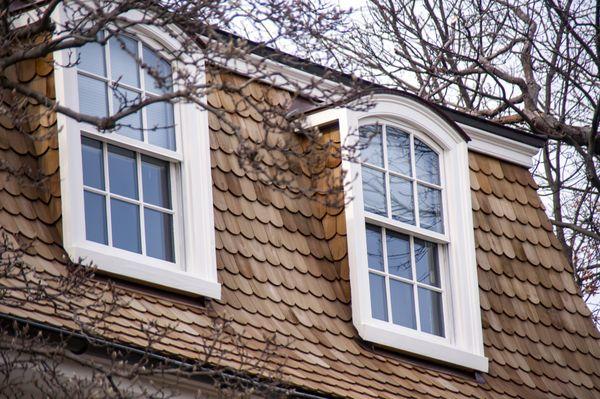 Some of our cedar shake work with accompanying copper gutters and dormer covers.