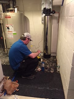 One of our esteemed plumbing partners hard at work installing an Aqua IQ system