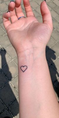 Heart, tattoo'd by chris! (The bump was an air bubble under the healing tape, not actually on my skin or tattoo)