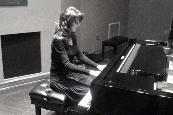 young adult taking piano lessons in Charlotte