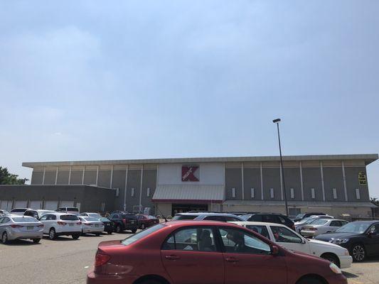 Glimpse of Kmart midway through their expansive parking lot, usually had half capacity, new life came here once more. (7/1/2018)