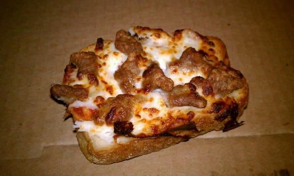 A slice of the garlic bread pizza with hamburger topping. It sucked ass. In fact, I bet my ass tastes better.