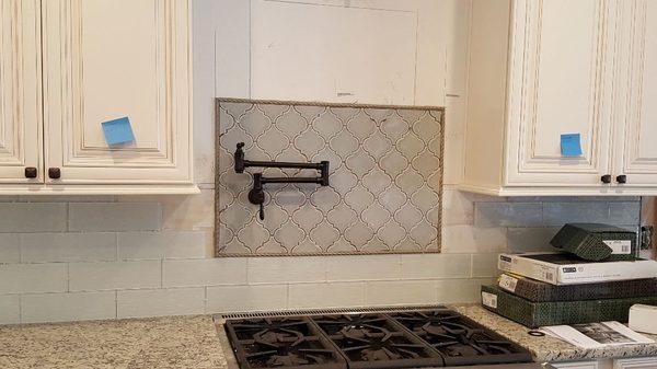 New pot filler over stove. Allows for easy access of filling large pots without having to lift them