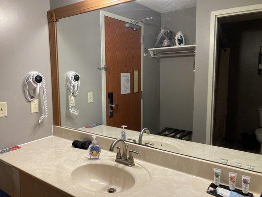 Sink and countertop just inside room door.