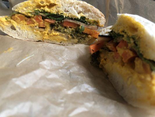 Ciabatta with pickled veggies, carrot hummus, and greens. If you like pickled things this is a must.