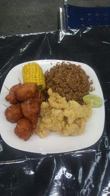 Golden conch fritters, cracked conch, peas and rice with a side of garlic corn.