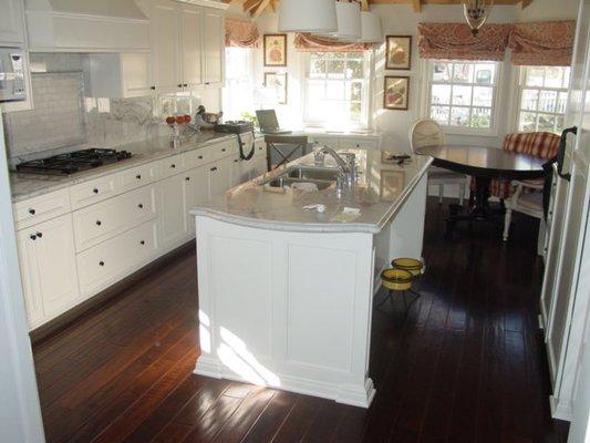 Craftsman Style Kitchen with Marble counter and solid wood floors.