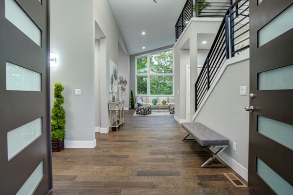 "Modernize your entryway with stunning staircase and flooring, adding contemporary elegance to your home's first impression.