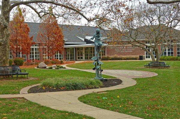 Statue of girl with a musical instrument in front of the Woodlawn Library,  Copyrighted Emily A. Reed, Ph.D.