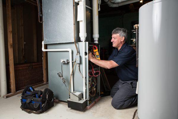 Anthony performing a gas furnace maintenance.