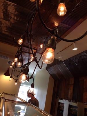 Love the Edison bulbs and reclaimed wood beam from 1890 above the topping bar