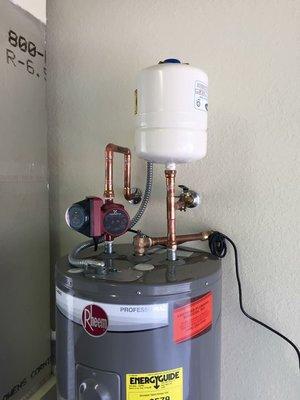 Water heater w/ expansion tank and hot water circulation pump w/ timer.