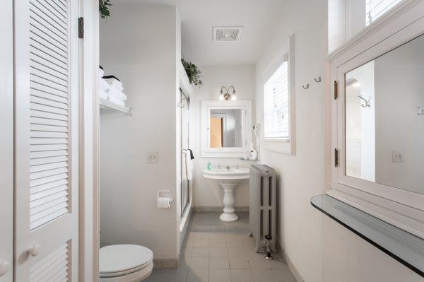 The Foster Room bathroom offers an abundance of light and a double steam shower.