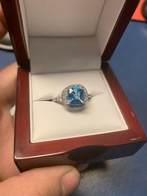 Custom made ring for customer blue topaz and diamonds.