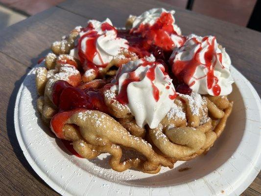 Regular funnel cake with whipped cream and strawberry topping