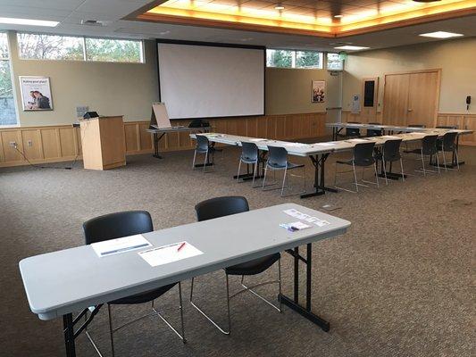 Non profit groups can reserve the room. Chairs and tables can be configured. Screen, projector, internet, and lectern are all provided.