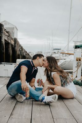 Couple kisses on a dock in South Boston, Massachusetts