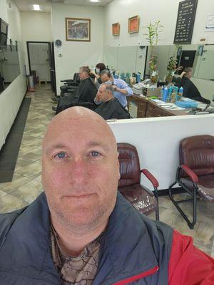 Just finished getting my hair cut...er umm head shaved by Andy owner of A.T 's Barber Shop.