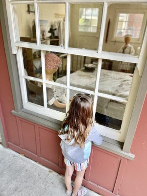 My daughter looking into the window at Capitola Historical Museum's "Capitola Then & Now" exhibition!