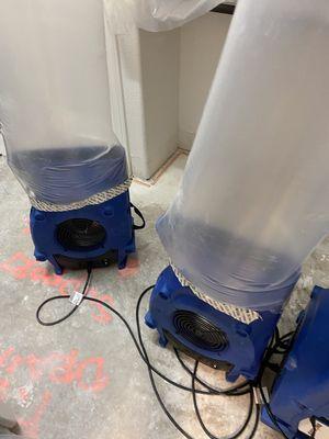 Air movers with the ducts to blow the air on wet ceiling