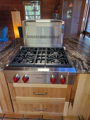 Wolfe stove top with Best downdraft and charcoal filtration system.