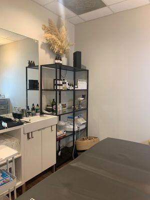 love the aesthetic of this place! storage/product display, cleaning area, waxing bed