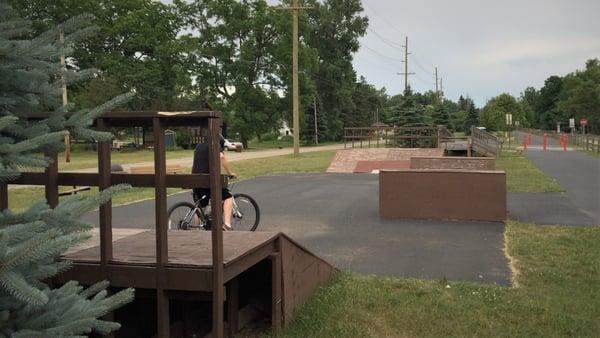 Wooded BMX ramps located near the Otter Lake parking area